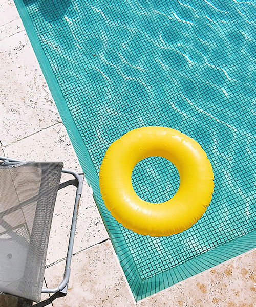 Colorful inflatable tube near swimming pool
